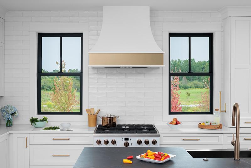 White modern kitchen with black windows. 