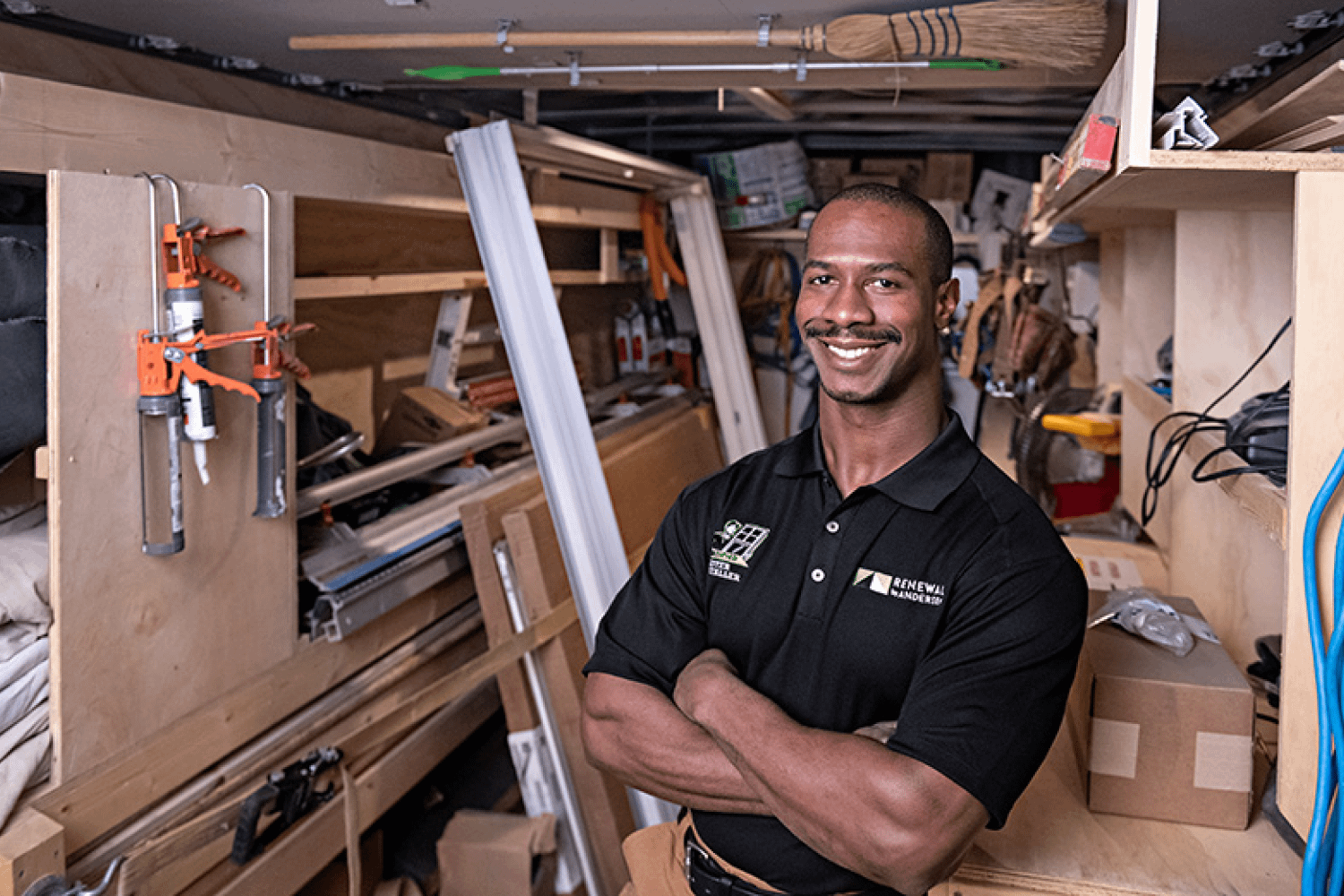 Installer standing in a room full of window installation materials