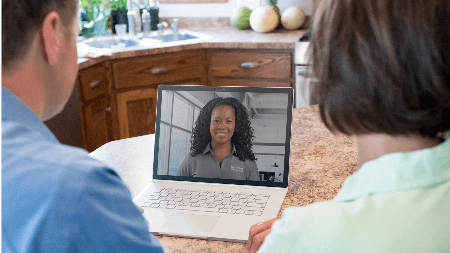 A virtual sales appointment with a Renewal by Andersen sales person, there are two homeowners looking into a video call