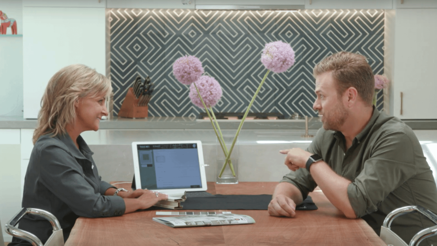 Sales person talking to a homeowner about their window replacement options