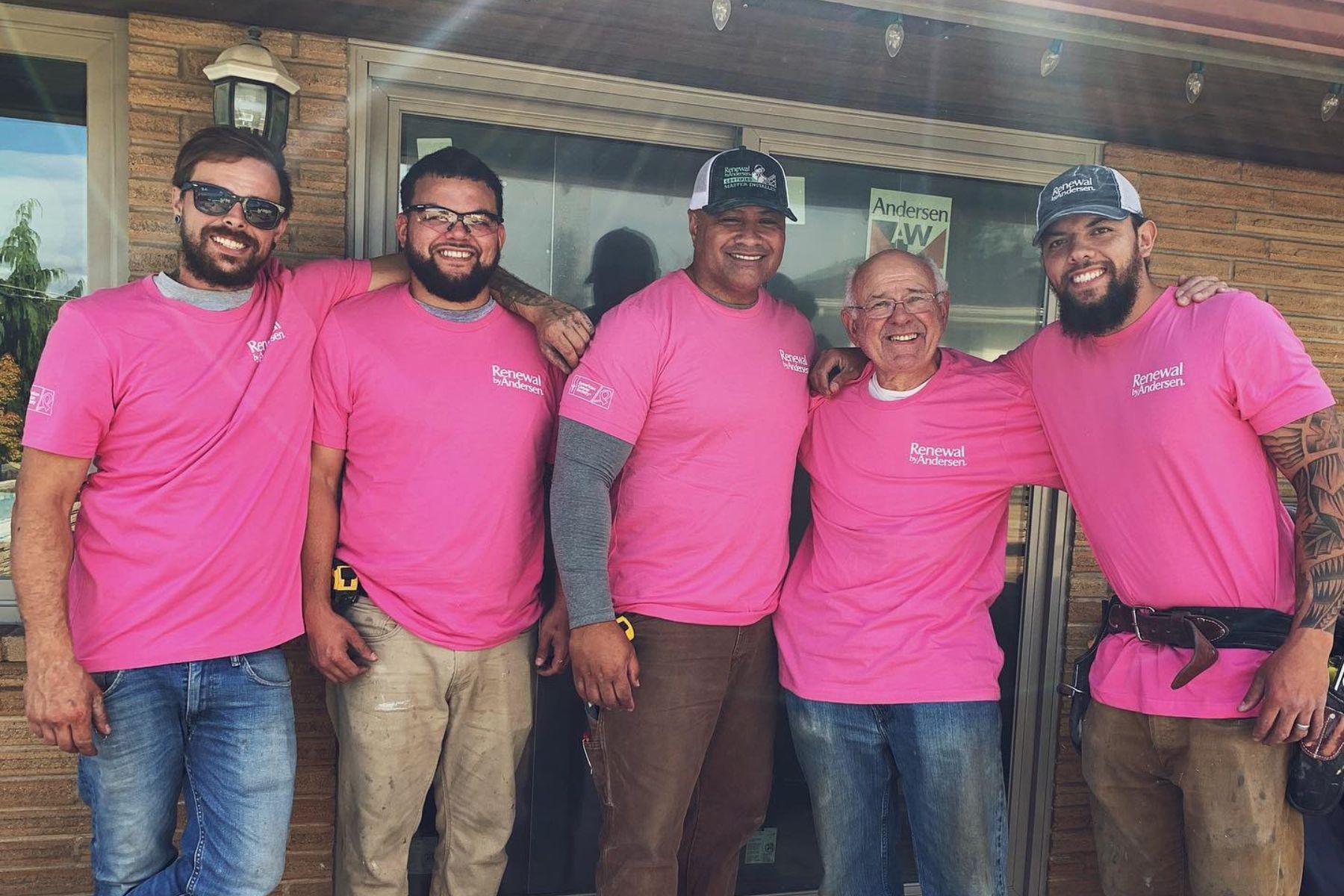 Group of installers showing support for ACS event in pink t-shirts 