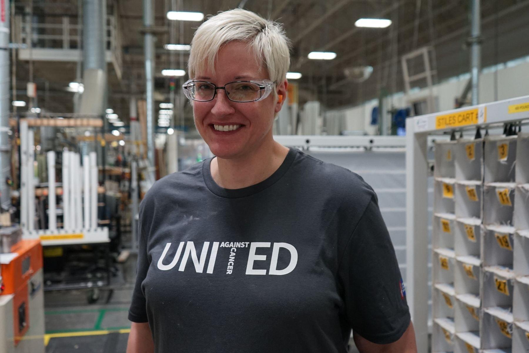 Portrait of RbA manufacturing employee wearing a United Against Cancer t-shirt.