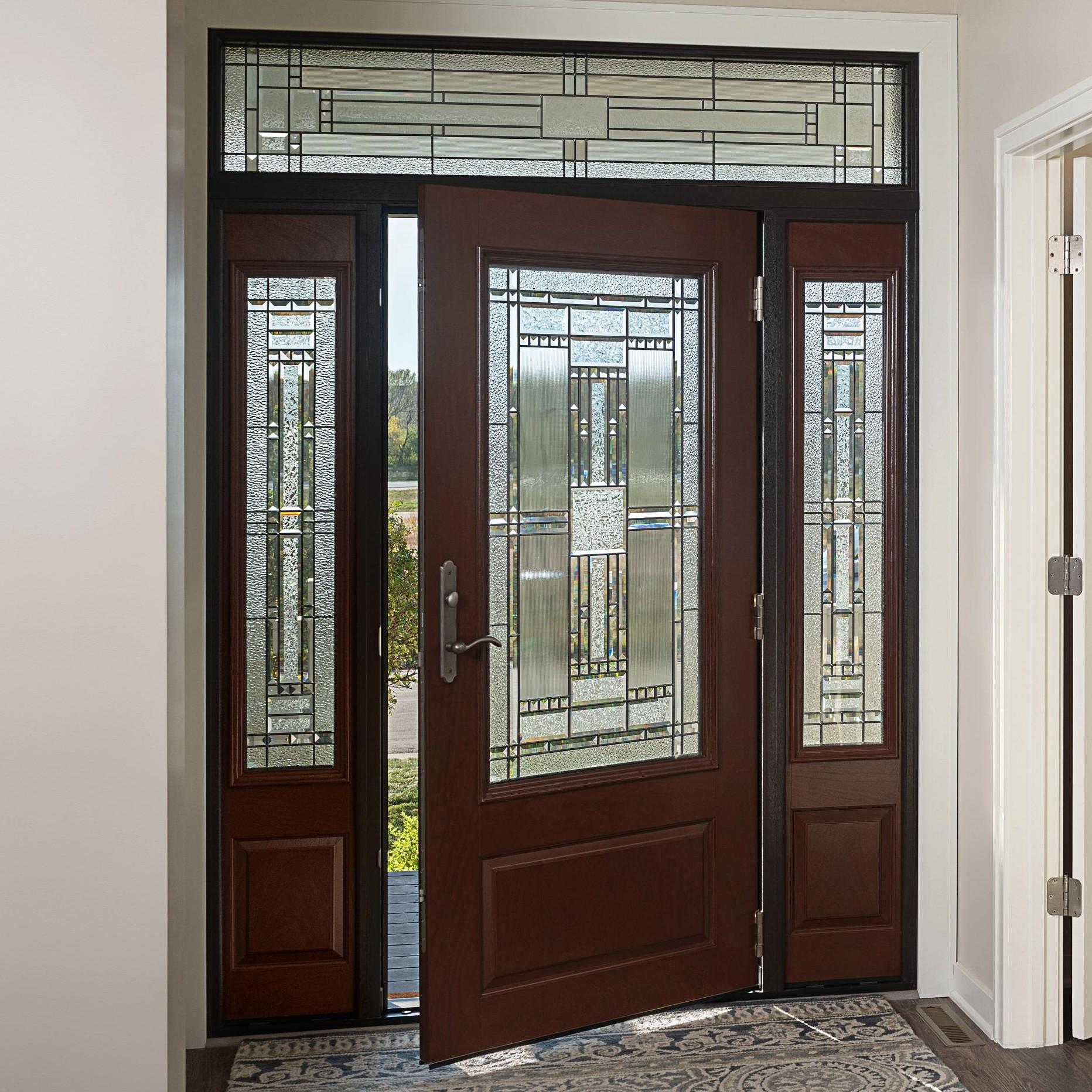 An Ensemble entry door with dual sidelights viewed from inside. The door has craftsman art glass and a wood finish.