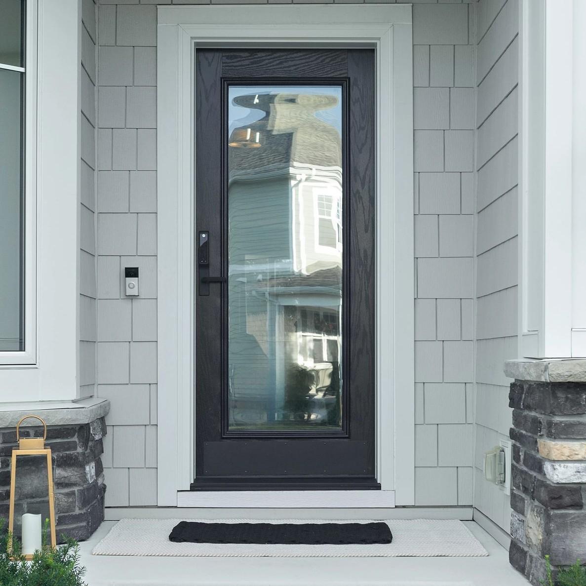 A single panel Ensemble entry door. The door is black and has full-light glass. It has white trim.