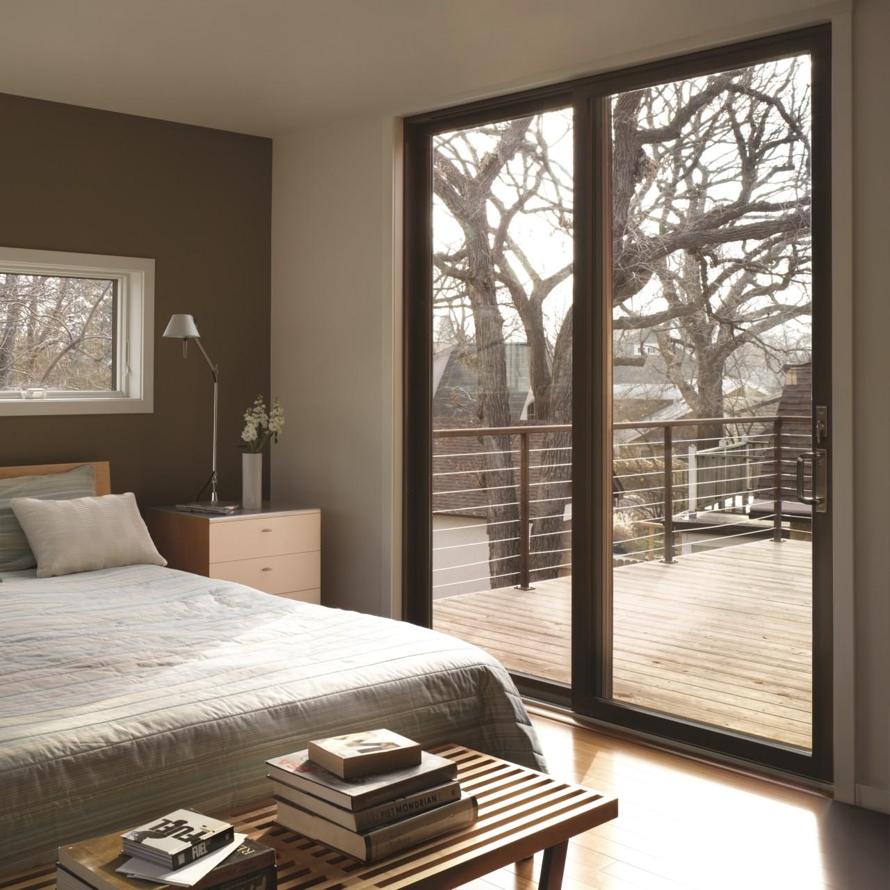 Black permashield patio doors. These sliding patio doors are very modern and open to the deck off the bedroom.