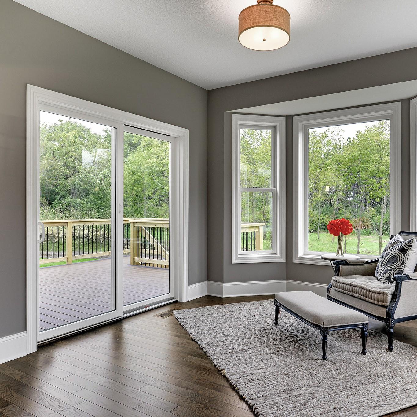 Permashield sliding patio doors. These are white patio doors with oil-rubbed bronze hardware. They are in a den.