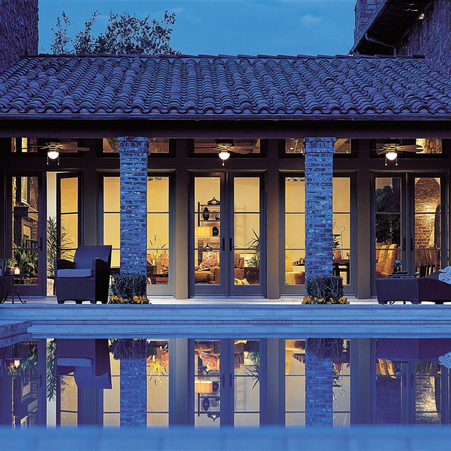 Terratone hinged French patio doors overlooking a swimming pool area.