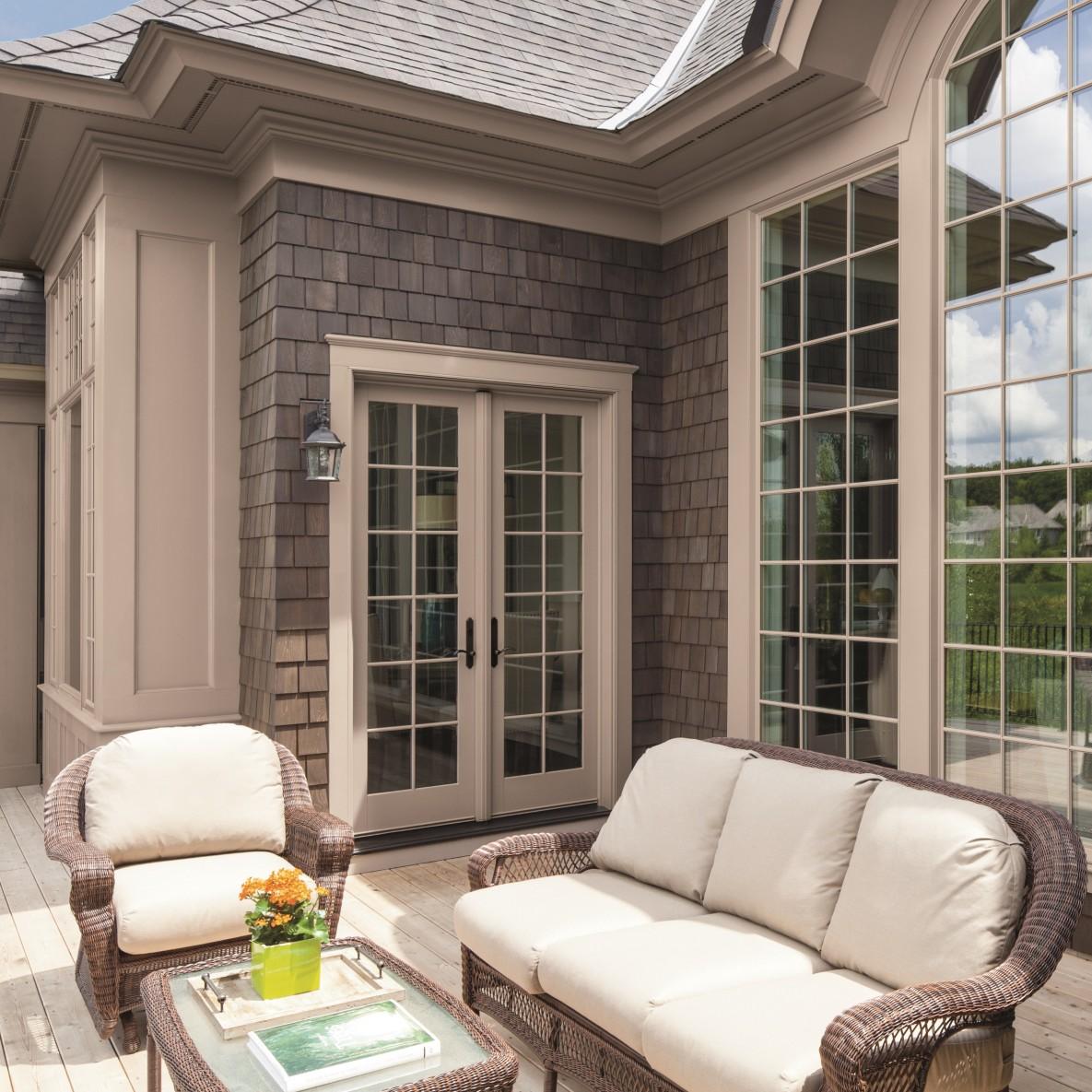 A set of french doors in Sandtone color. These french doors have colonial grilles.