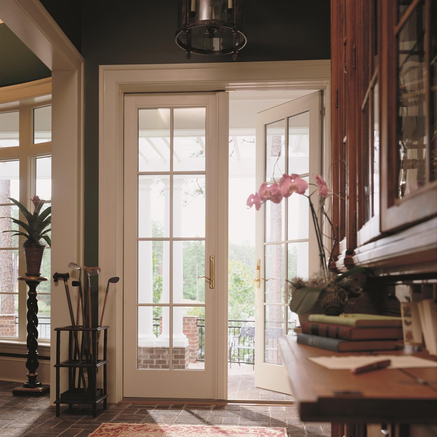 A pair of narrow french doors. The doors swing out to save space in the room.