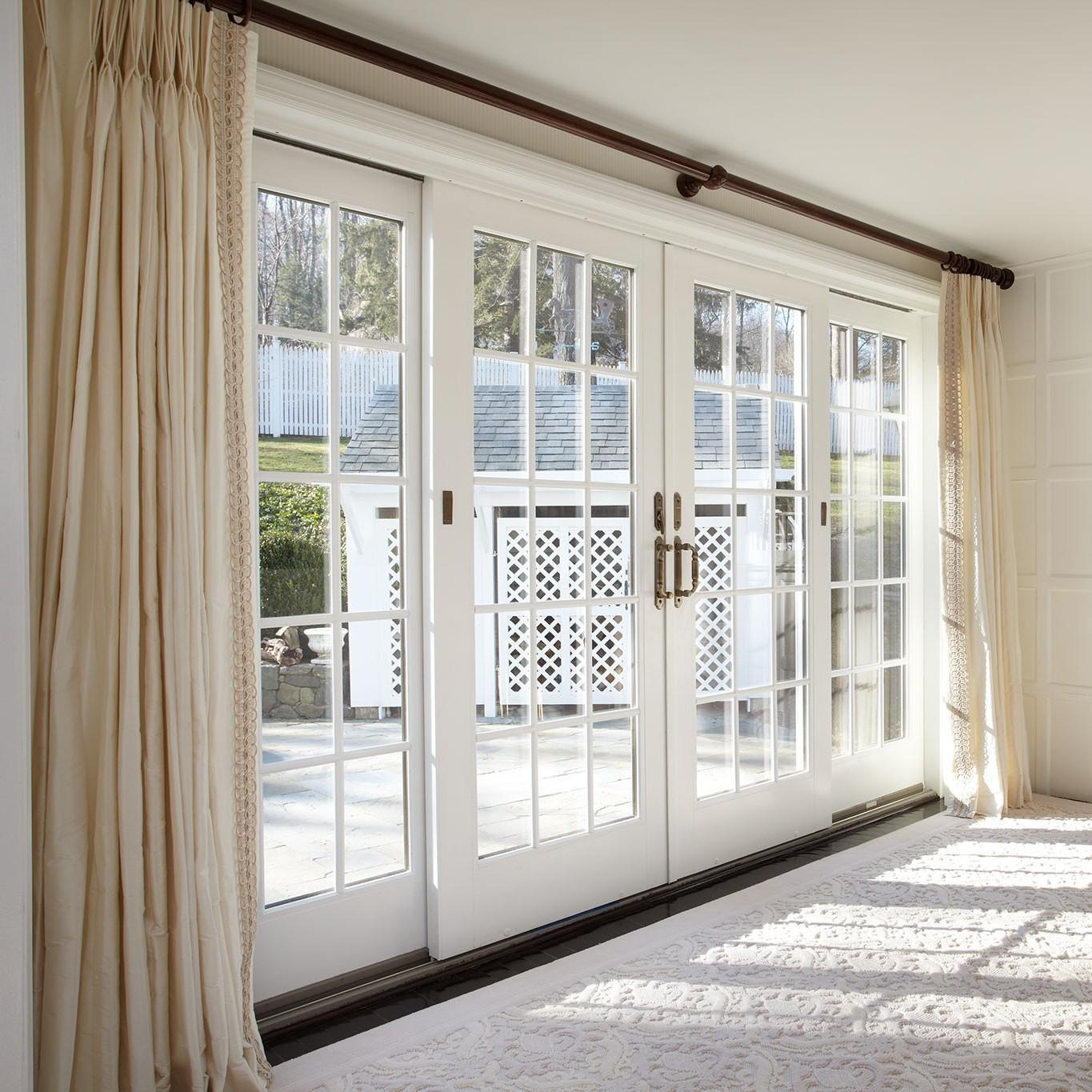 A bank of four patio doors. Two are fixed and just let in light. Two are sliding French doors that open to create a large opening.