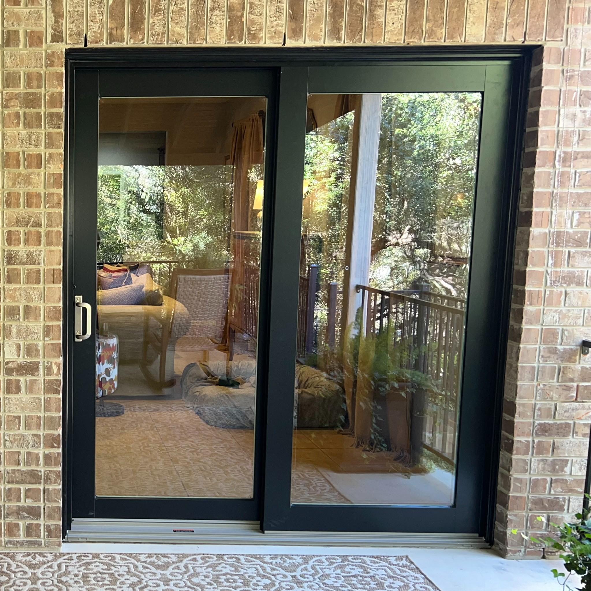 A series contemporary doors. These are black sliding glass doors and have brushed nickel hardware.