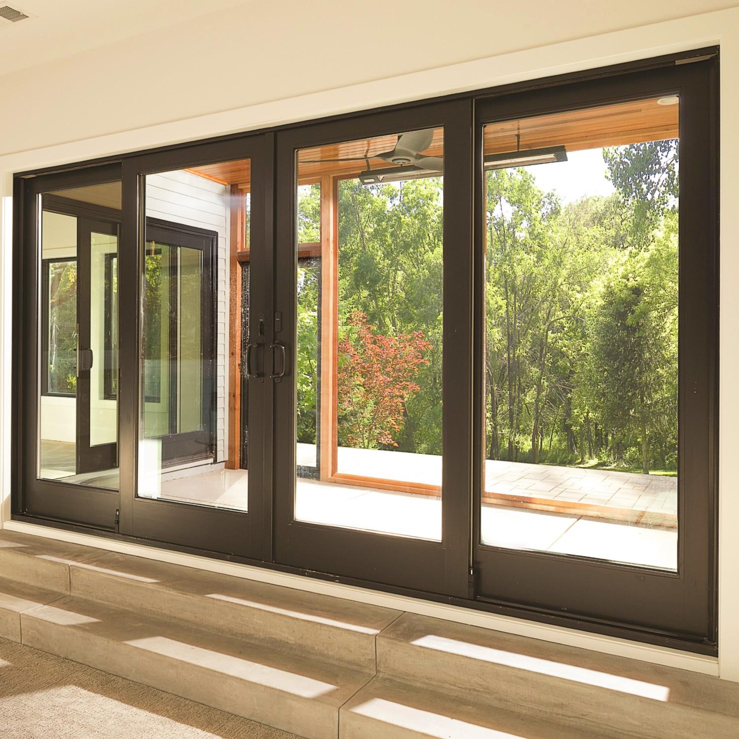 A bank of four traditional A-series doors in black. Two are sliding patio doors.