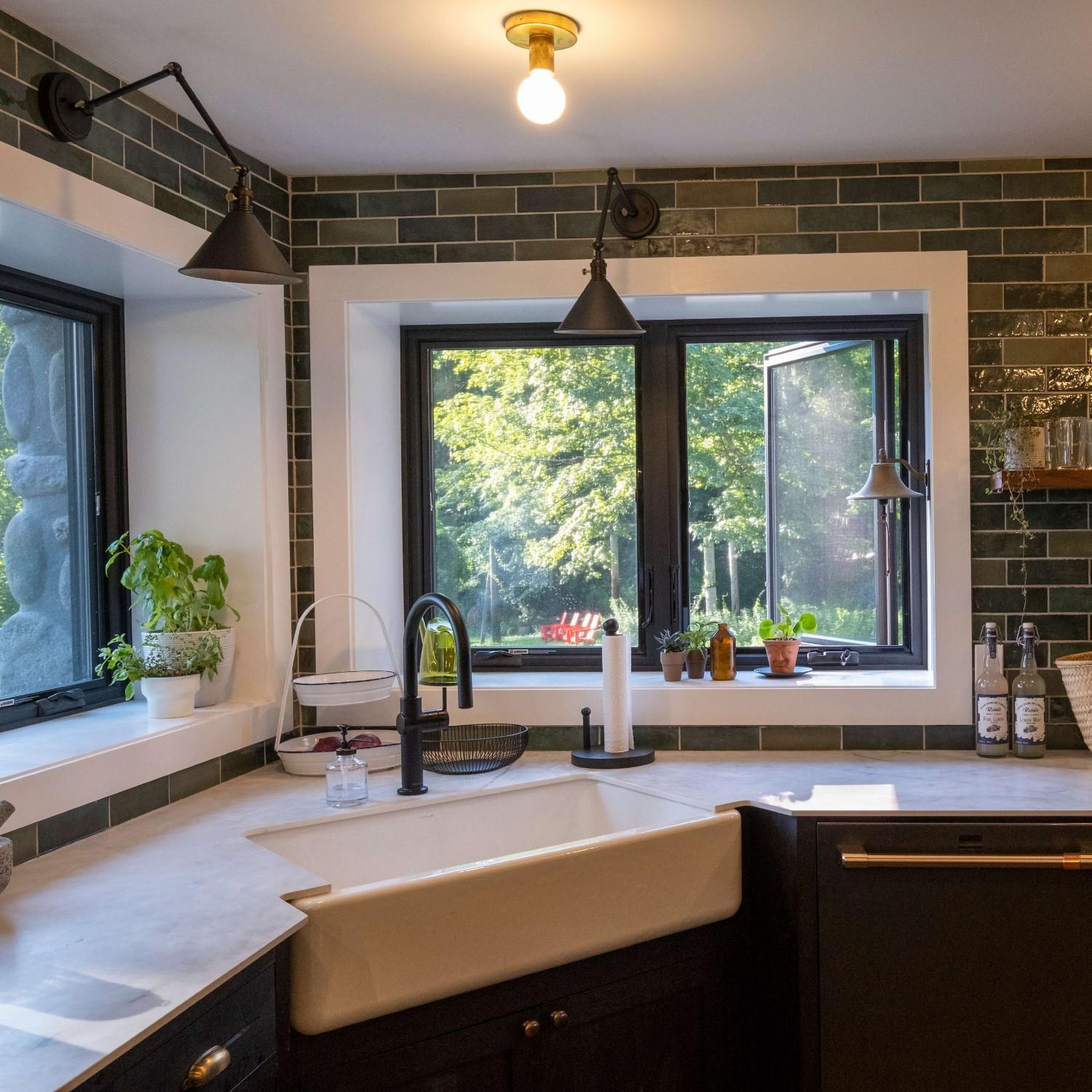 Black kitchen window in the casement style. Behind the sink in a corner. It is a mountain lodge.