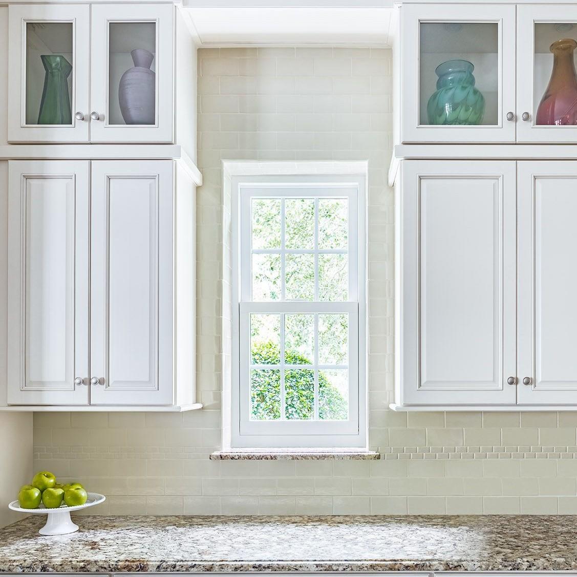 Double hung windows can be large or small. Even the tightest spaces can have a window, like this between cabinets.