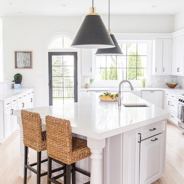 The arched manor kitchen. It has a specialty window, an andersen patio door, and a picture window.