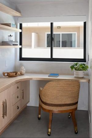 An office space in breegan Jane's home. The room has glider windows.