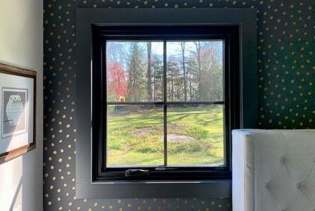 John's bedroom features neat square windows with equal lite grilles.