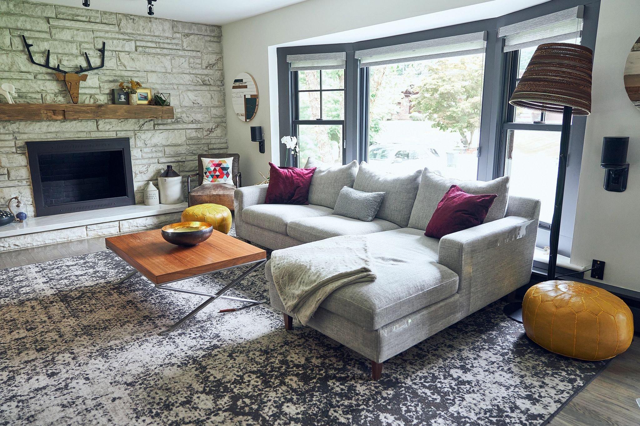 John's bay window inside his living room. He also has a large rug.