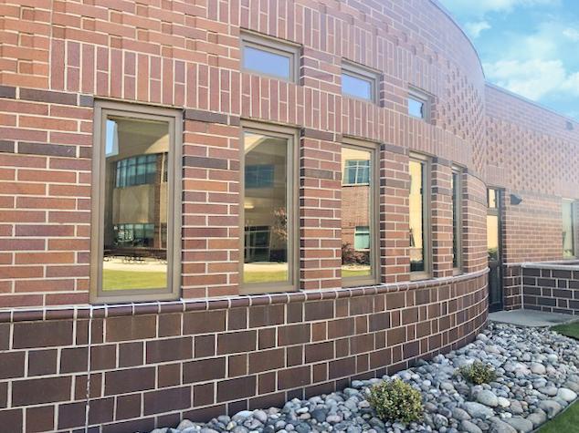 Exterior shot of brick building with multiple Renewal by Andersen windows